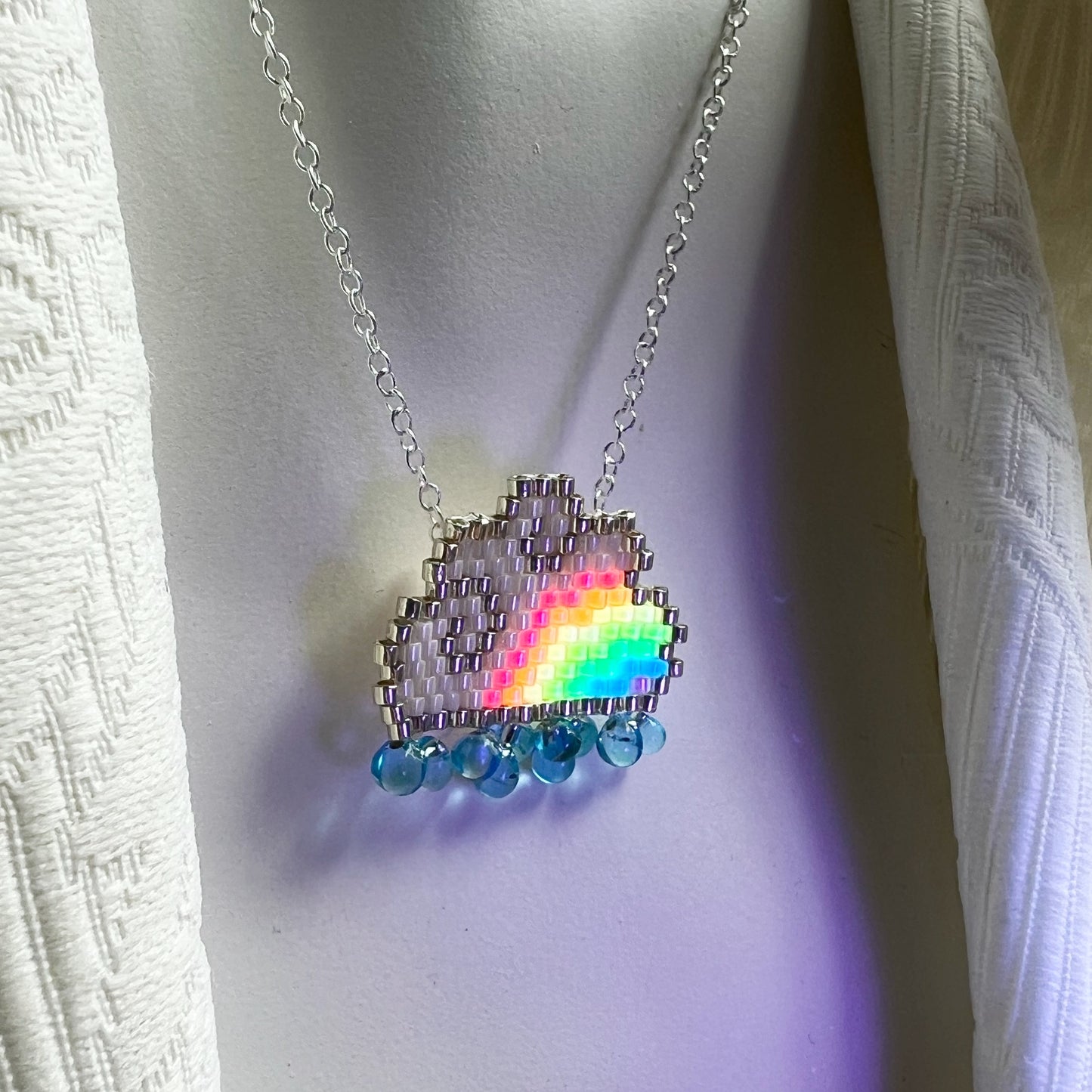 Raincloud necklace with fluorescent UV rainbow beads