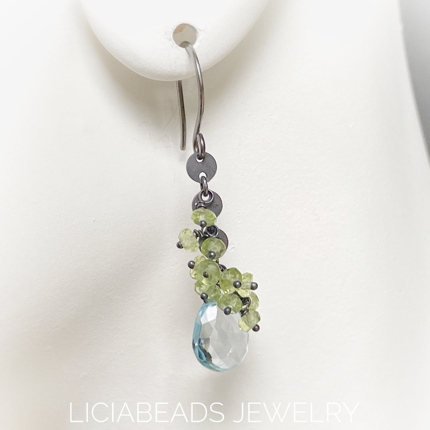 Blue Topaz and peridot gemstones on blackened sterling silver