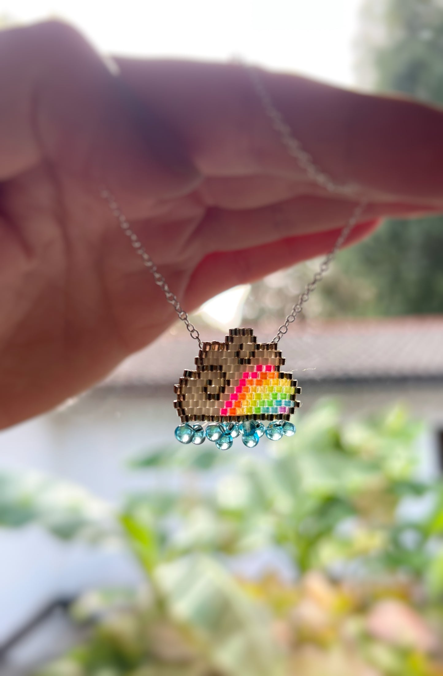 Raincloud necklace with fluorescent UV rainbow beads