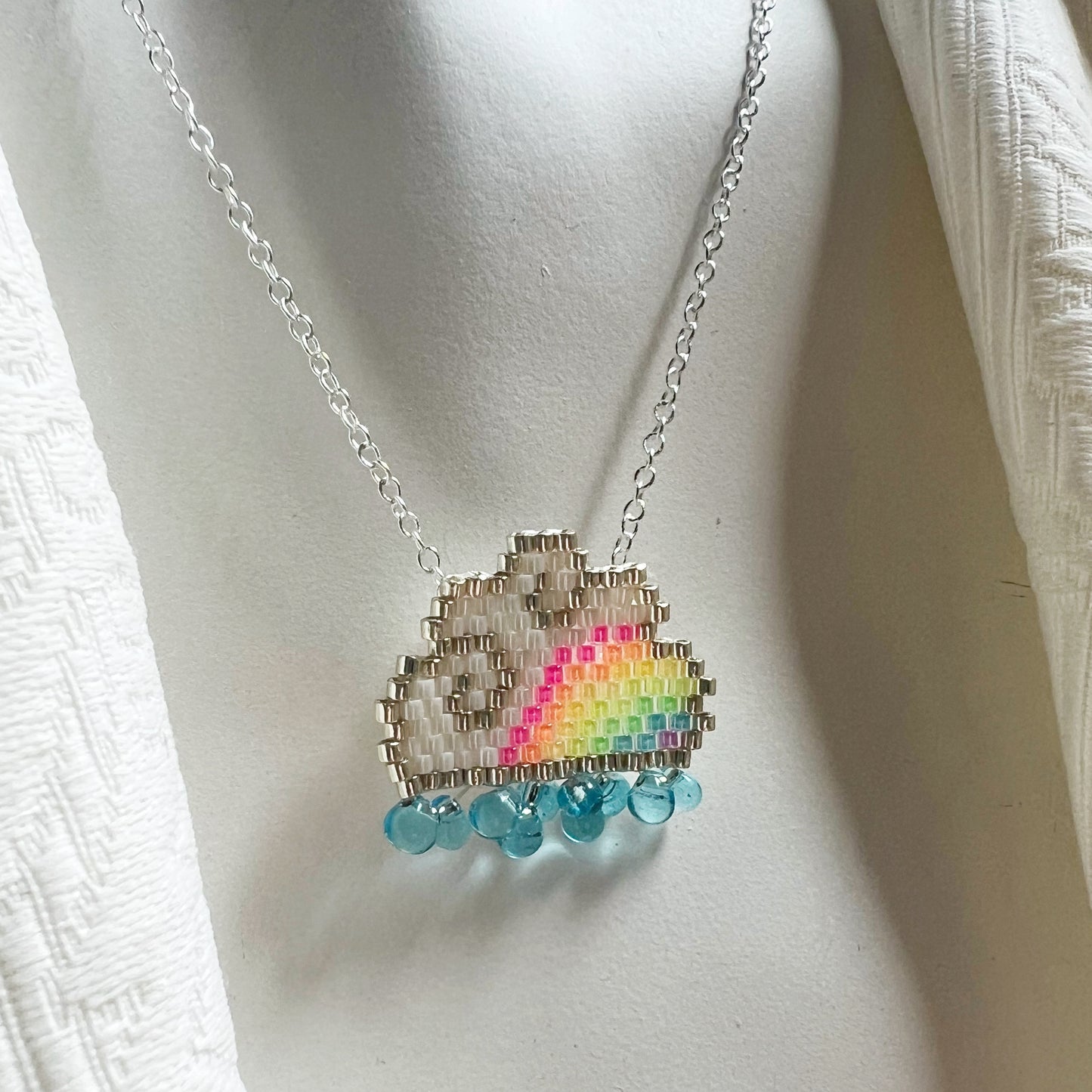 Raincloud necklace with fluorescent UV rainbow beads