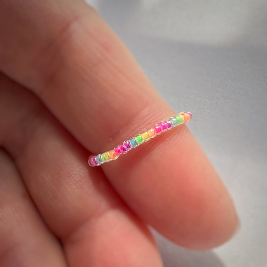 Ring in rainbow luminous blacklight beads (mini bead size)